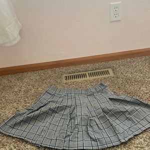 An black and white and gray with a flannel pattern above the knee tight  waist .